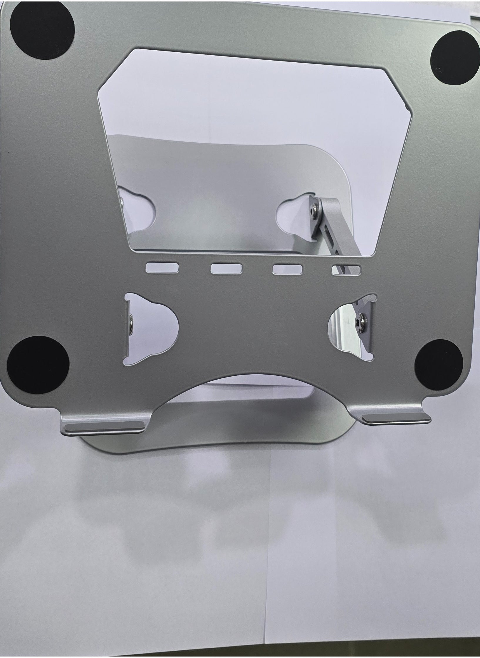 Silver aluminum alloy foldable and adjustable laptop stand, compatible with 14-17 inch laptops, designed for stability and ergonomic support.